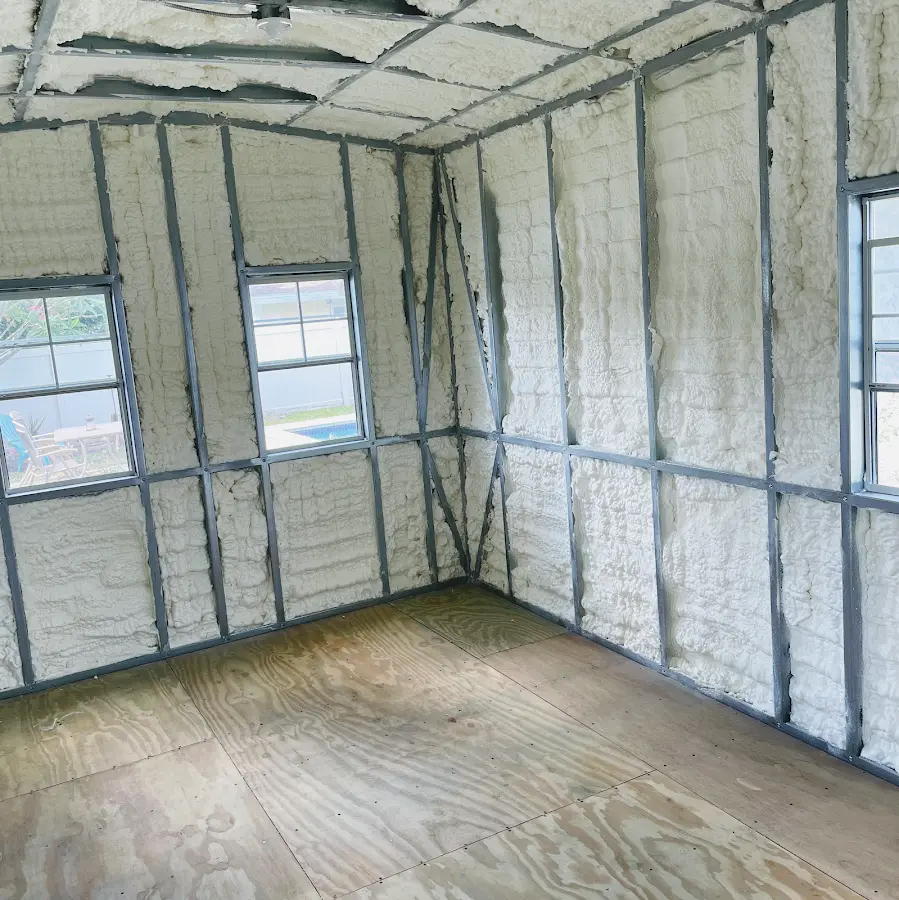 Closed-cell spray foam insulation applied to wall cavities in a residential project in Wharton